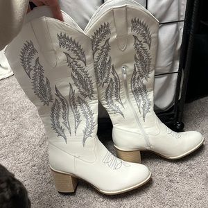 White tall cowboy boots with side zipper. Never worn